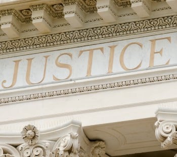 Justice Word Engraved On Law Firm Building