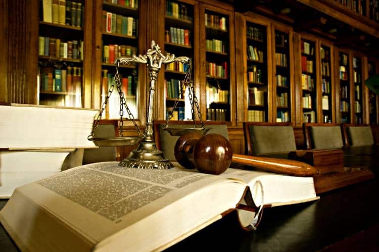 Law Books With Gavel And Scales Of Justice In Legal Library