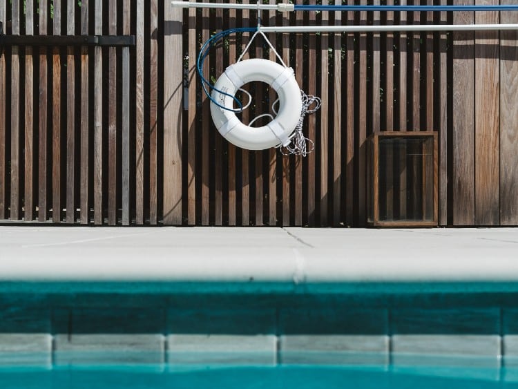 swimming pool with wooden gate & lifesaver hanging